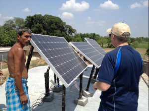 Brad_Mattson_installing_solar_panels_in_an_off-grid_Indian_village,_June_2013_